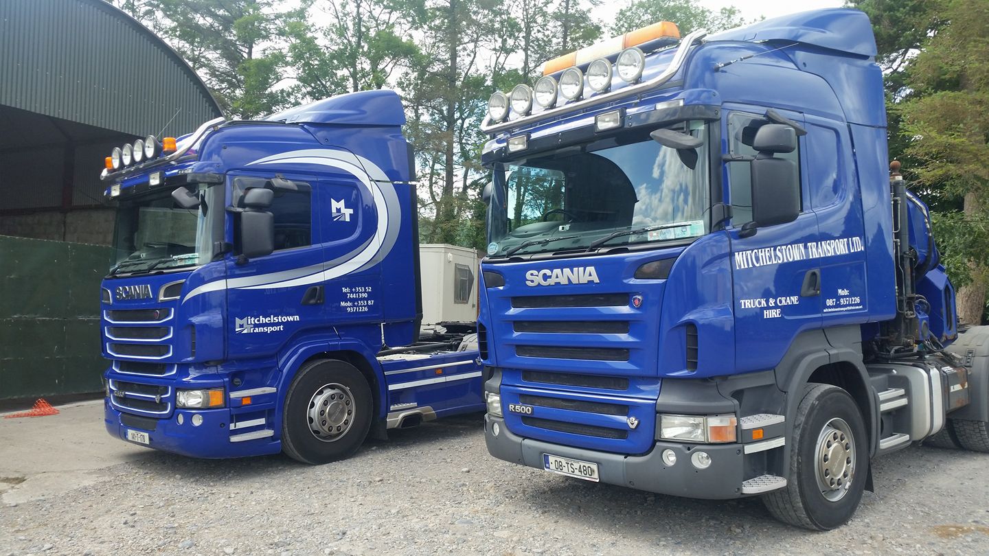 image of two transport trucks parked together.