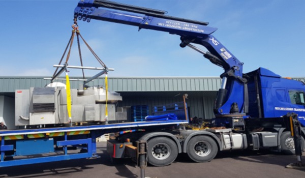 truck relocating items in a factory